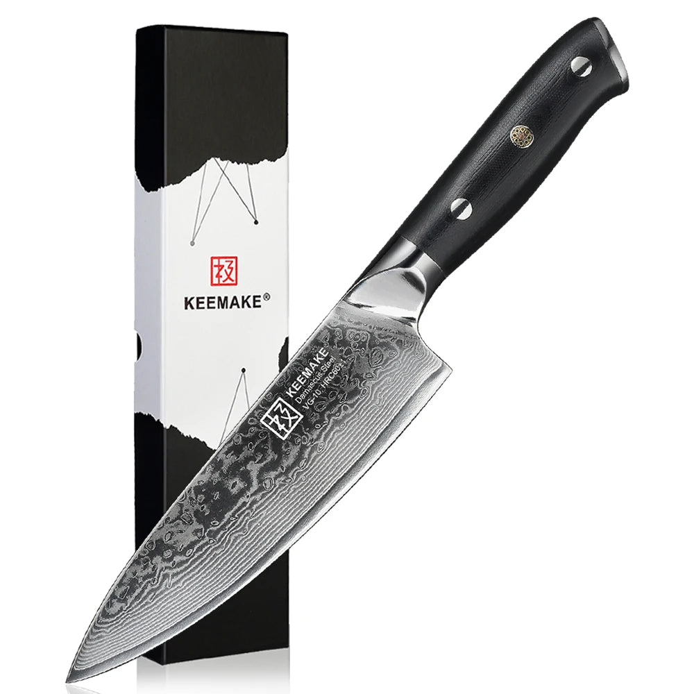 Chef knife with black handle and Damascus steel blade next to its packaging on a white background