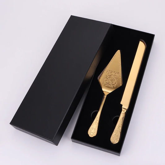 Gold cake server and knife set in a black box on a white background
