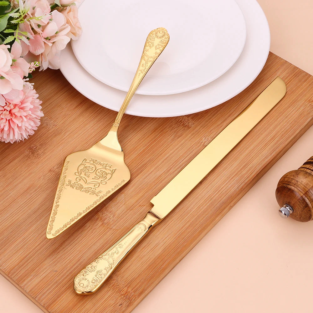 Gold cake server set on a wooden board with flowers and plates in the background