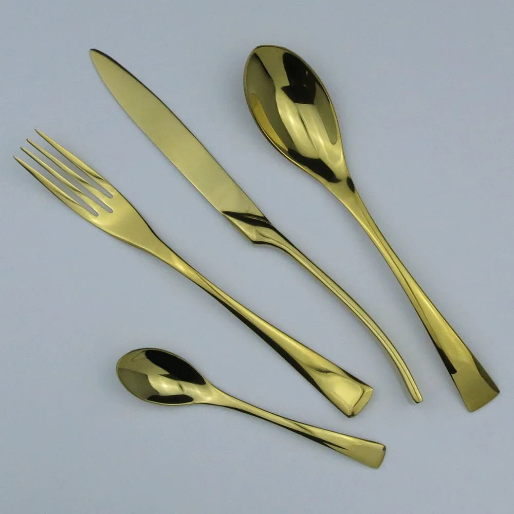 Set of gold cutlery including a fork, knife, and two spoons on a light gray background.