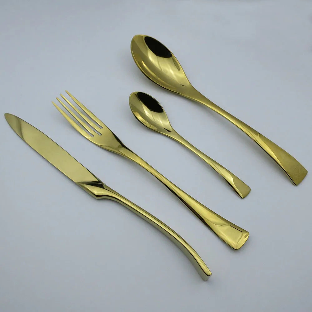 Set of gold-colored cutlery including a knife, fork, and two spoons on a light gray background.