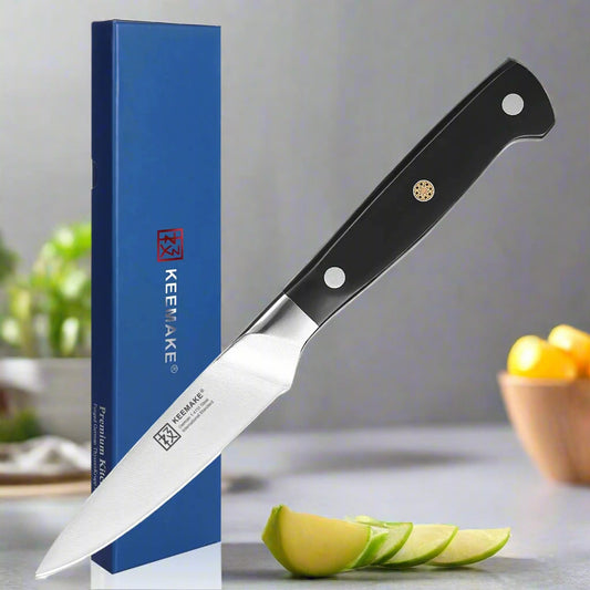 Knife with black handle and silver blade next to a blue KEEMAKE box on a white background