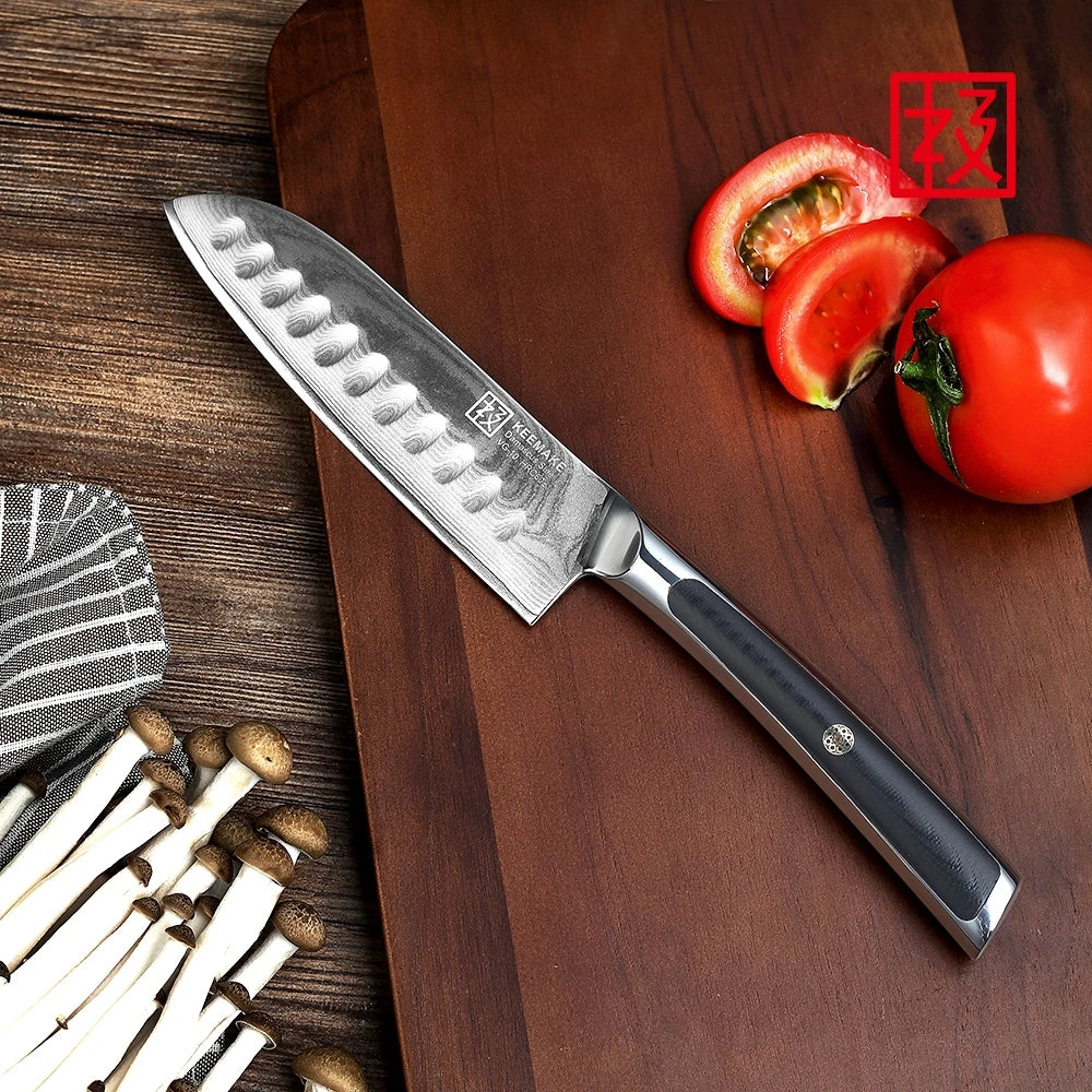 Chef's knife on a wooden cutting board with tomatoes and mushrooms