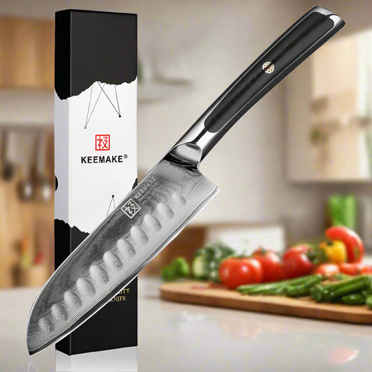 KEEMAKE knife with black handle and branded packaging on a white background