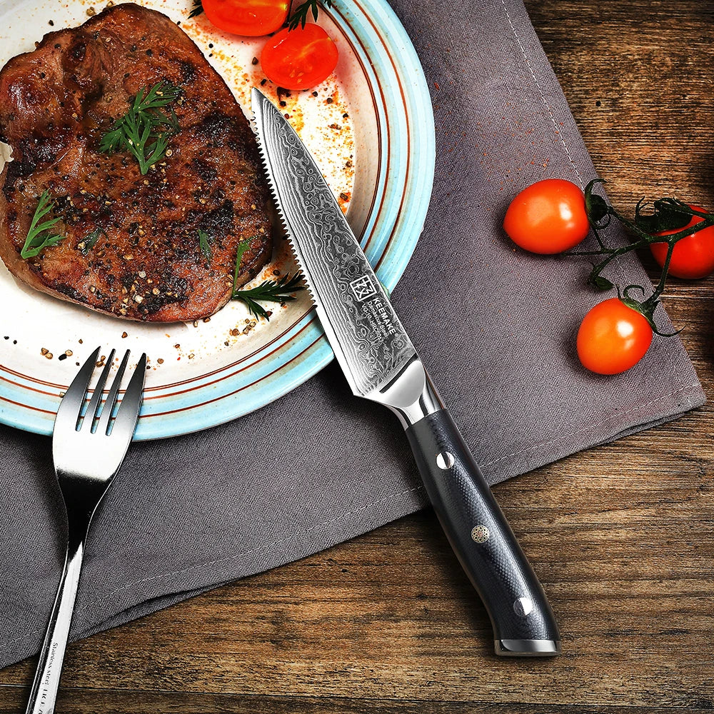 Steak on a plate with a knife, fork, and tomatoes on a wooden table