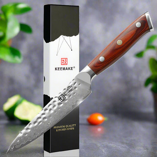 Keemake kitchen knife with wooden handle and branded packaging on a white background