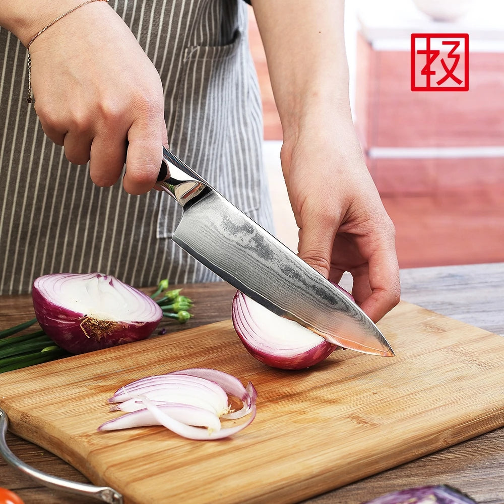 Person slicing an onion on a wooden cutting board with a chef's knife.