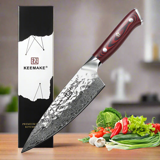 Kemake kitchen knife with a wooden handle next to its packaging and fresh vegetables on a white background