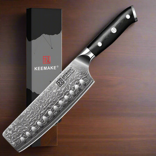 Knife with a KEEMAKE branded box on a maple wood background