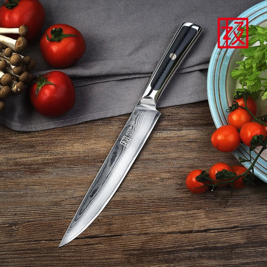 Knife with a brand logo on a wooden surface with tomatoes and herbs