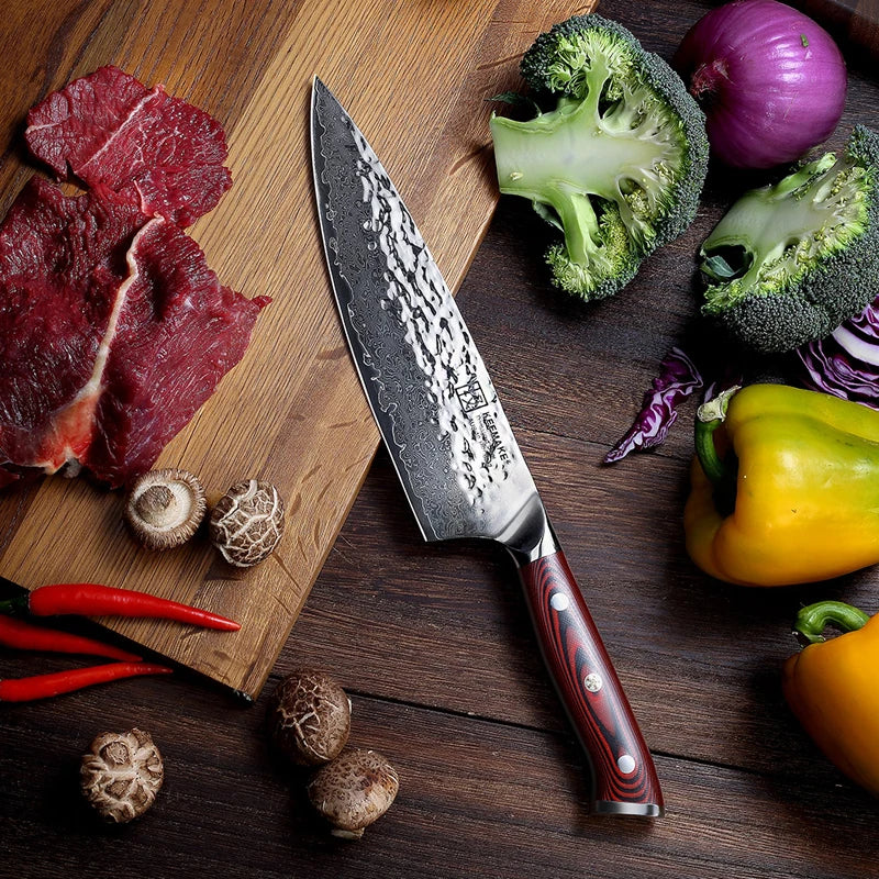 Chef's knife on a wooden cutting board with raw meat, vegetables, and mushrooms.