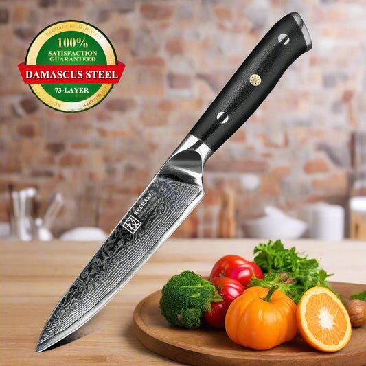 Chef's knife with Damascus steel blade and black handle, surrounded by fruits on a white background.