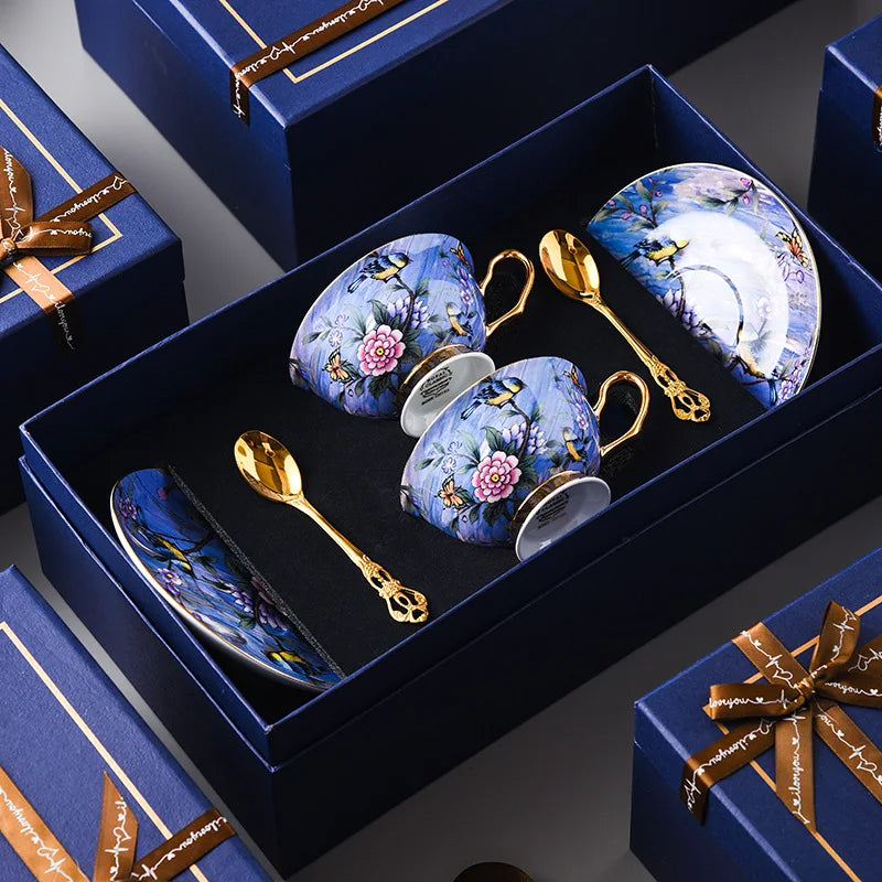 Decorative tea set with floral designs in a blue box