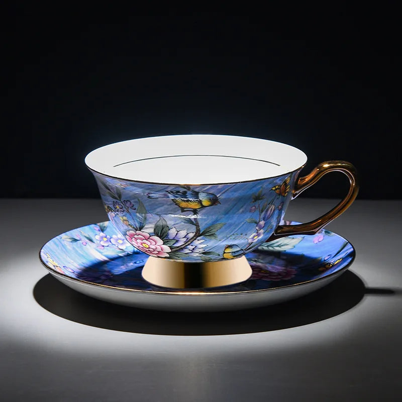 Decorative teacup and saucer with floral design on a dark background