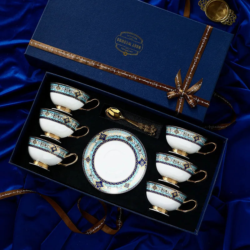 Tea set with decorative cups and saucer in a gift box on a blue satin background