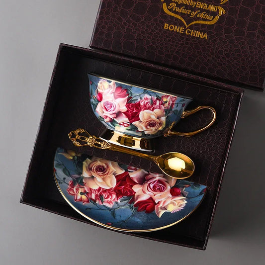 Floral teacup and saucer set with spoon in a decorative box, featuring bone china branding.