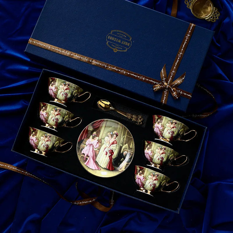 Set of decorative teacups and saucers in a gift box on a blue satin background