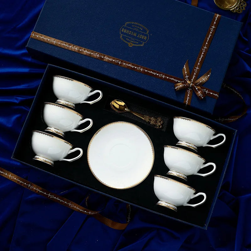 Ceramic tea set with six cups and a plate in a decorative box on a blue satin background.