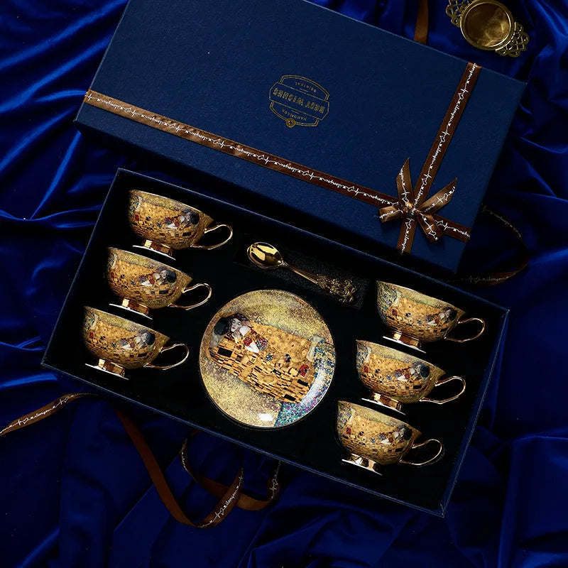 Set of decorative cups and saucers in a gift box on a blue fabric background