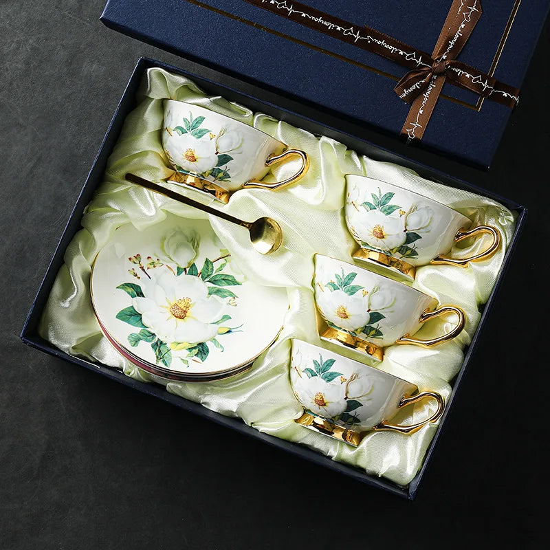 Set of ceramic tea cups and saucers with floral design in a decorative box.