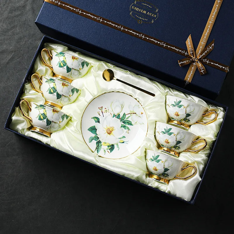 Tea set with floral design in a decorative box on a dark background